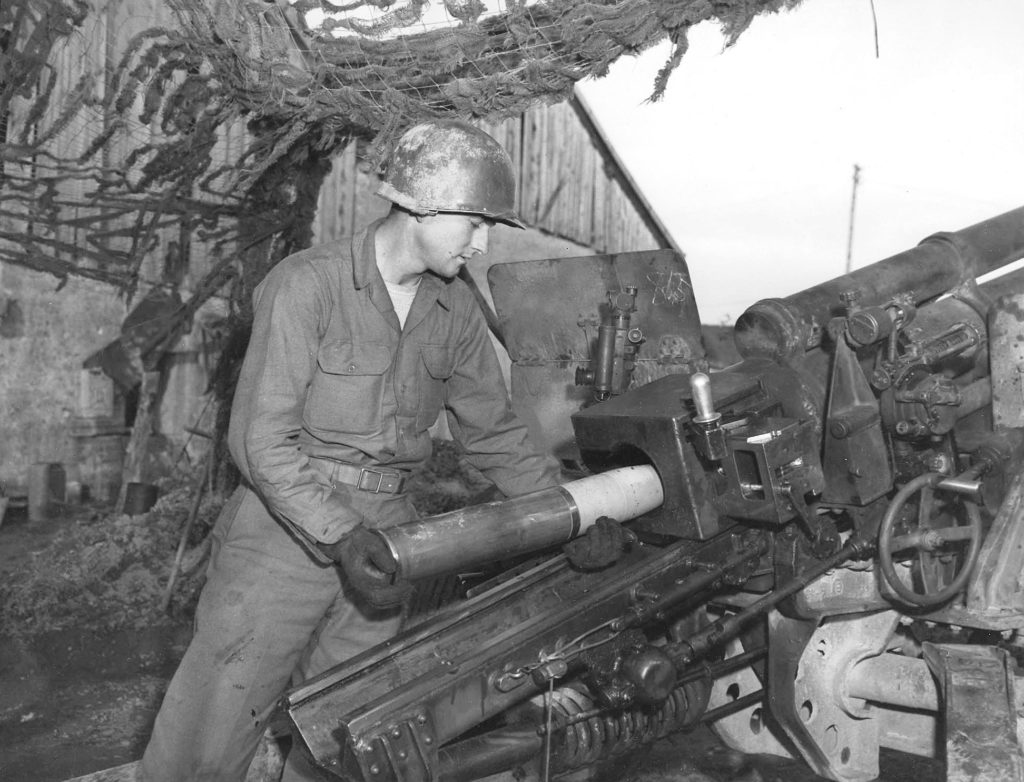 A member of the 131st Field Artillery Battalion loading a 105mm shell packed with D-ration chocolate bars for an infantry battalion cut off in the Belmont Sector, France, 29 Oct 1944. I didn't know you could do this, but it checks out.