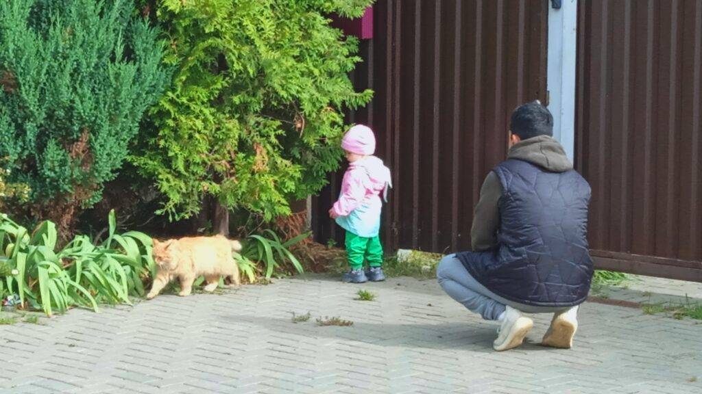 A girl and a cat and her dad